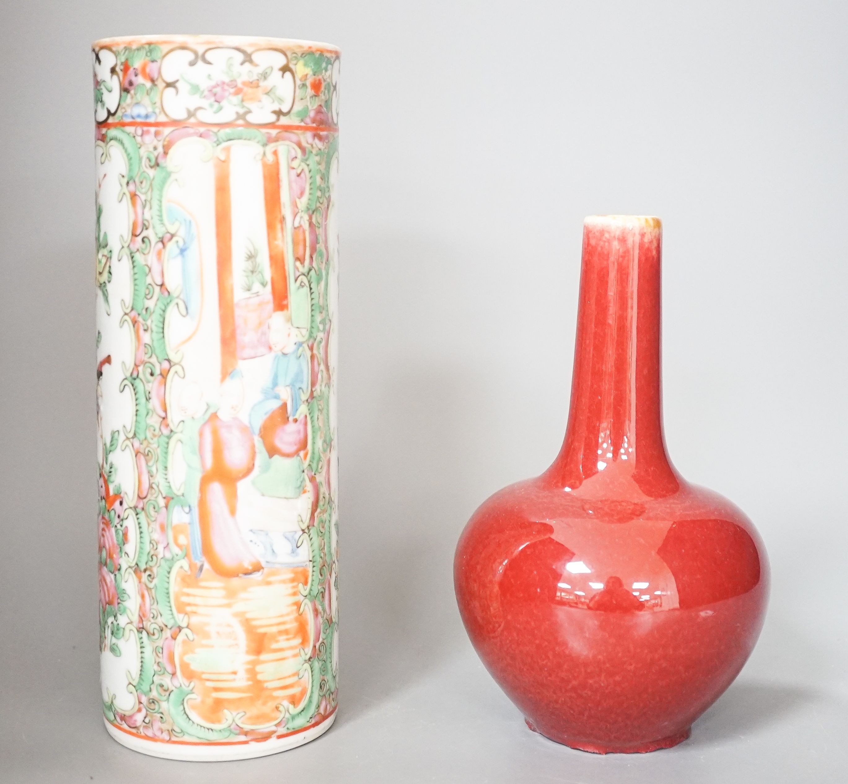 A Chinese famille rose cylindrical vase and a flambé bottle vase vase, tallest 24 cm